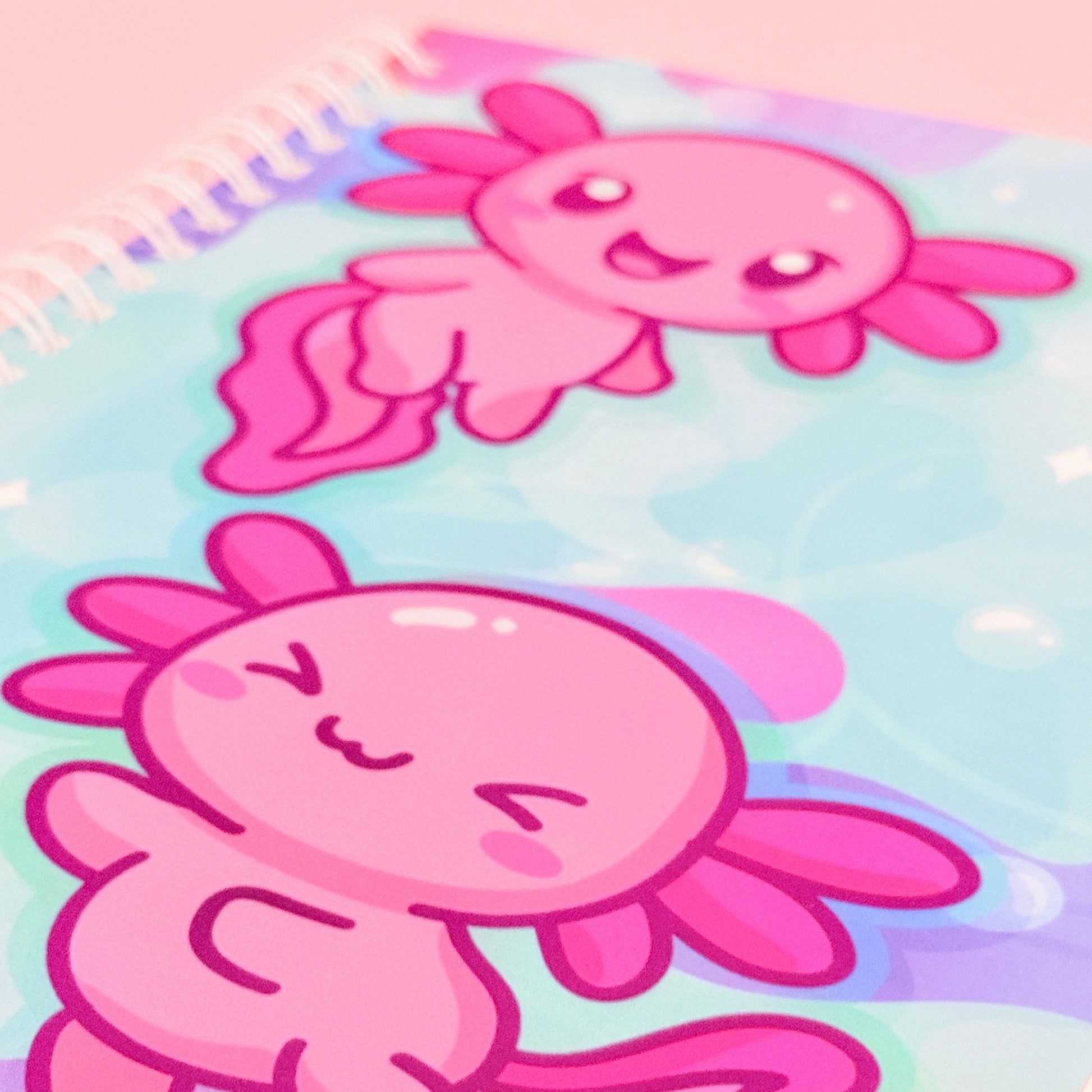 Two pink cartoon axolotls on a colorful gradient background